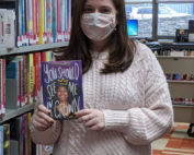 photo of reader holding up book titled You Should See Me in a Crown