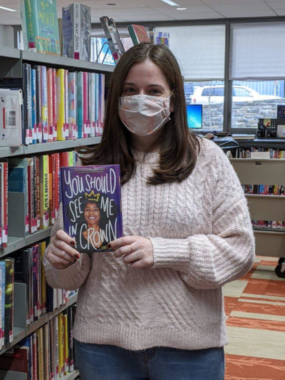 photo of reader holding up book titled You Should See Me in a Crown